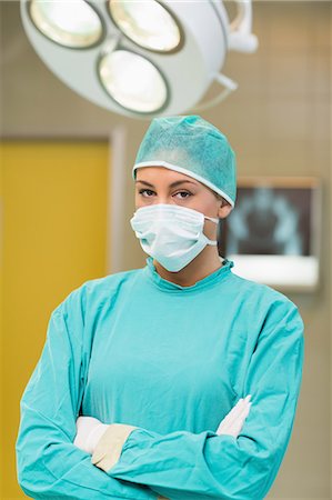 female doctor serious - Nurse wearing a surgical equipment with arms crossed Stock Photo - Premium Royalty-Free, Code: 6109-06195764