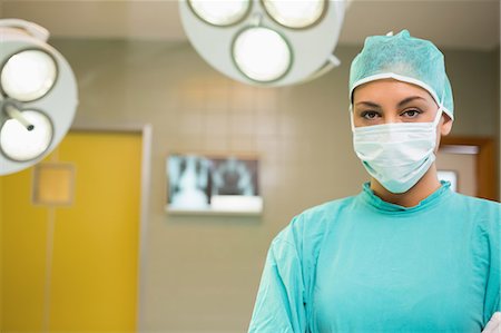 serious surgeon with mask - Serious nurse wearing surgical clothes Stock Photo - Premium Royalty-Free, Code: 6109-06195769