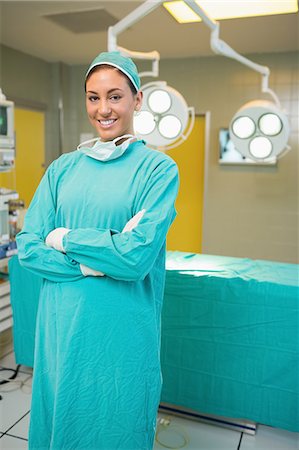 female nurse with mask and gloves - Nurse standing with arms crossed while smiling Stock Photo - Premium Royalty-Free, Code: 6109-06195783