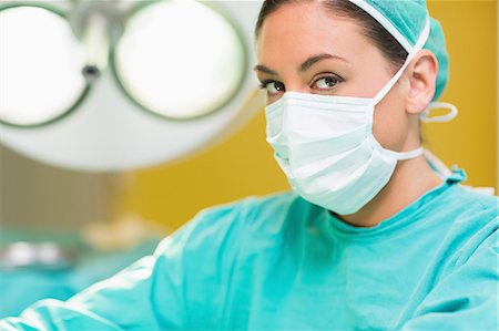 female nurse with gloves - Serious female surgeon looking at camera Stock Photo - Premium Royalty-Free, Code: 6109-06195794