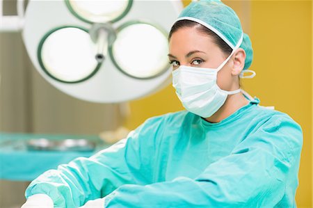 Concentrated female surgeon looking at camera Stock Photo - Premium Royalty-Free, Code: 6109-06195795
