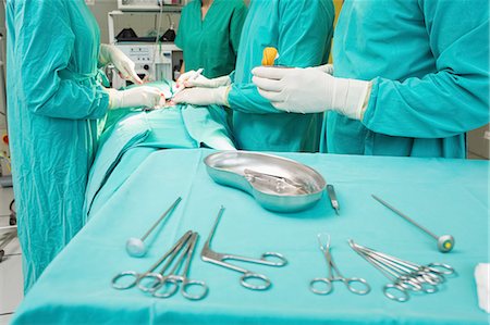 surgery tray - Close up of surgical tools next to surgeons Stock Photo - Premium Royalty-Free, Code: 6109-06195853