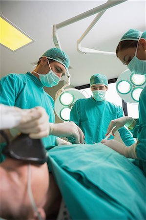 Focus on surgeons operating Stock Photo - Premium Royalty-Free, Code: 6109-06195895