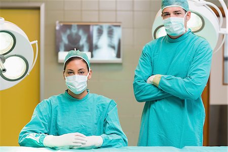 surgeon gloves blue - Two surgeons looking at camera Stock Photo - Premium Royalty-Free, Code: 6109-06195800