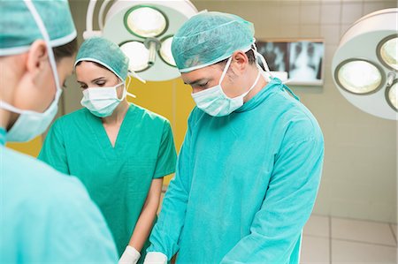 simsearch:6109-06195999,k - Surgeons wearing a surgical equipment Stock Photo - Premium Royalty-Free, Code: 6109-06195805