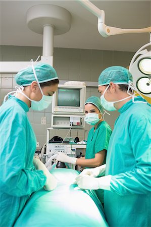 patient with monitors in hospital - Surgical team operating Stock Photo - Premium Royalty-Free, Code: 6109-06195815