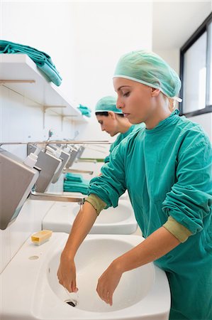 doctor washing hands - Nurses putting hands and forearms under water Stock Photo - Premium Royalty-Free, Code: 6109-06195950