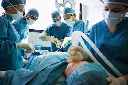 emergency - Unconscious patient being operated by a team of surgeons Stock Photo - Premium Royalty-Free, Code: 6109-06195971