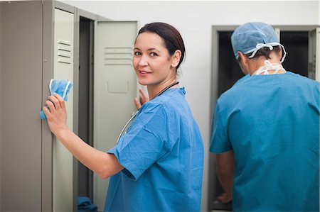 female locker room pictures - Smiling female surgeon in a locker room Stock Photo - Premium Royalty-Free, Code: 6109-06196052