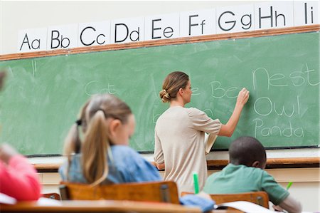 school children - Teacher writing on board Foto de stock - Sin royalties Premium, Código: 6109-06196444