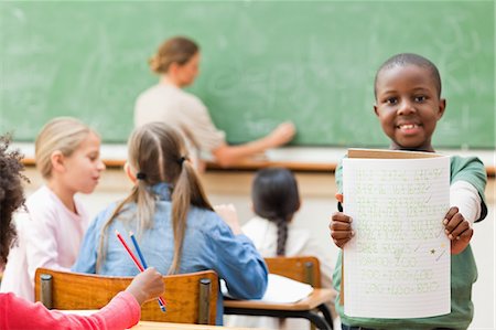 scuola elementare - Student showing his exercise book Fotografie stock - Premium Royalty-Free, Codice: 6109-06196466