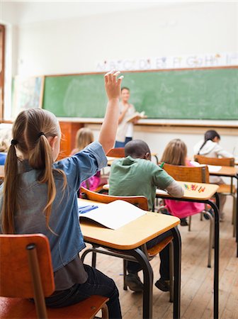 Back view of elementary school student raising hand during lesson Stock Photo - Premium Royalty-Free, Code: 6109-06196421