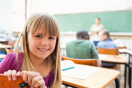 school boy looking back - Smiling girl turning around during lesson Stock Photo - Premium Royalty-Free, Code: 6109-06196426