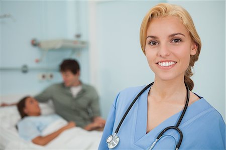 Blonde nurse smiling next to a patient Fotografie stock - Premium Royalty-Free, Codice: 6109-06684683