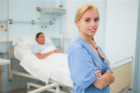 patient happy in bed - Nurse with crossed arms next to a patient Stock Photo - Premium Royalty-Free, Code: 6109-06684681