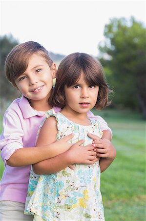 person hugging tree - Cute brother giving his sister a hug Stock Photo - Premium Royalty-Free, Code: 6109-06684751