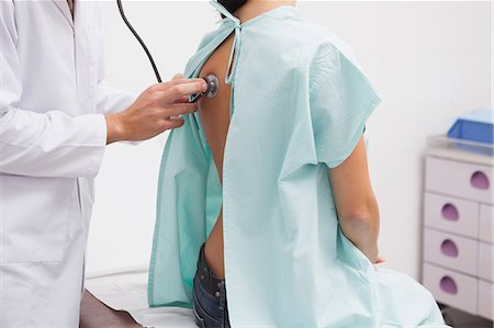 examination table - Close up of doctor auscultating the patient back with a stethoscope Stock Photo - Premium Royalty-Free, Code: 6109-06684703