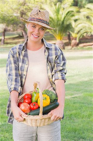 planting tomato plant - Pretty blonde carrying basket of vegetables Stock Photo - Premium Royalty-Free, Code: 6109-06684866