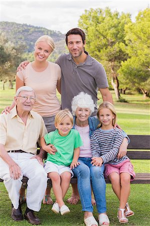 father son sitting on a bench - Portrait of multi-generation family at the park Stock Photo - Premium Royalty-Free, Code: 6109-06684868