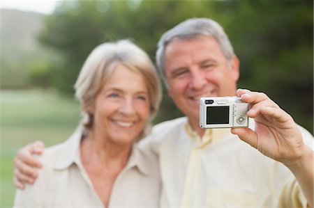 simsearch:6109-06684830,k - Couple taking a photo of themselves Stock Photo - Premium Royalty-Free, Code: 6109-06684899