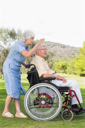 senior wheelchair outside - Elderly woman pointing out something partner in wheelchair Stock Photo - Premium Royalty-Free, Code: 6109-06684830