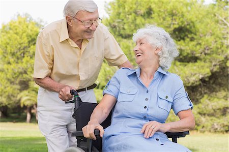 simsearch:6109-06684830,k - Elderly man laughing with his partner in a wheelchair Stock Photo - Premium Royalty-Free, Code: 6109-06684832