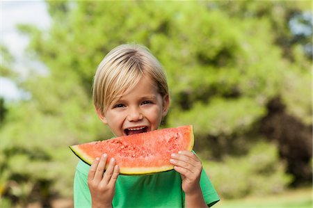 Cute happy boy eating watermelon Stock Photo - Premium Royalty-Free, Code: 6109-06684976