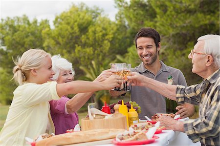 raised - Family toasting each other at lunch with champagne Photographie de stock - Premium Libres de Droits, Code: 6109-06684979