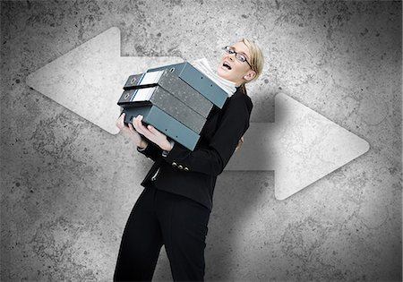 Woman struggling with work load Stock Photo - Premium Royalty-Free, Code: 6109-06684994