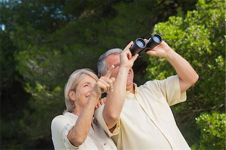 simsearch:6109-06684830,k - Woman pointing something out to partner looking through binoculars Stock Photo - Premium Royalty-Free, Code: 6109-06684927