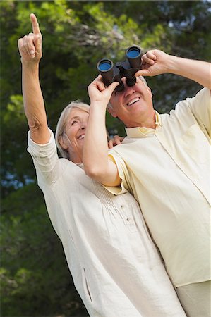 simsearch:6109-06684830,k - Smiling woman pointing something out to partner looking through binoculars Stock Photo - Premium Royalty-Free, Code: 6109-06684928