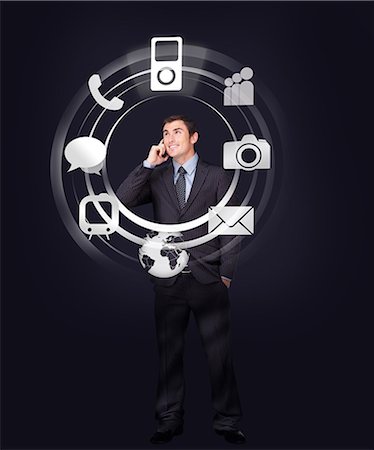 digital graphics images - Businessman on the phone looking at wheel of applications light up Stock Photo - Premium Royalty-Free, Code: 6109-06685042