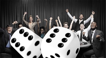 Attractive group cheering at the casino with digital dice Foto de stock - Sin royalties Premium, Código: 6109-06685007