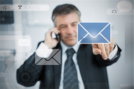 Businessman selecting email application on touchscreen Stock Photo - Premium Royalty-Free, Code: 6109-06685025