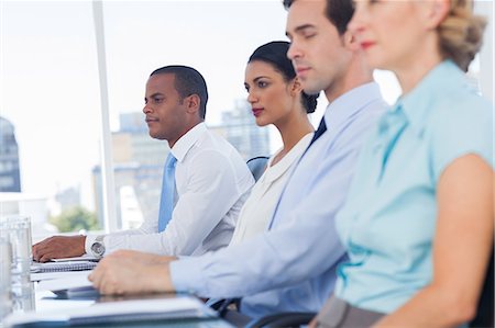 Colleagues sitting in line Stock Photo - Premium Royalty-Free, Code: 6109-06781344