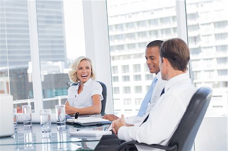 Smiling businesswoman discussing with colleagues Stock Photo - Premium Royalty-Free, Code: 6109-06781363