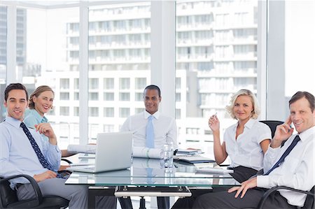 simsearch:6109-08203160,k - Business people looking at camera during a meeting Stock Photo - Premium Royalty-Free, Code: 6109-06781360