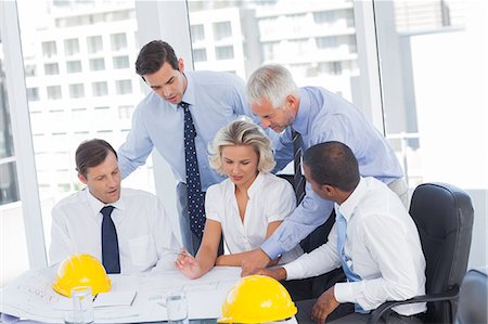 smiling corporate man woman - Architects working on construction plan Stock Photo - Premium Royalty-Free, Code: 6109-06781379