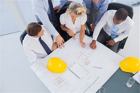 Business people working on construction plan Stock Photo - Premium Royalty-Free, Code: 6109-06781381