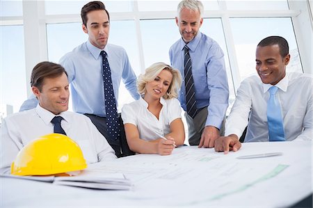 Business people discussing construction plan Stock Photo - Premium Royalty-Free, Code: 6109-06781384