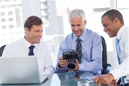 simsearch:6109-06781400,k - Business men looking at a camera Foto de stock - Sin royalties Premium, Código: 6109-06781388