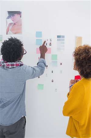 professionals whiteboard - Designers pointing at a group of photos Stock Photo - Premium Royalty-Free, Code: 6109-06781483