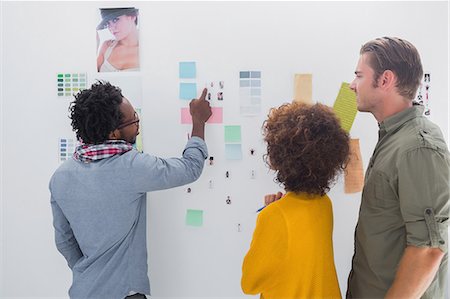 post it notes - Team of designers pointing at a group of photos Stock Photo - Premium Royalty-Free, Code: 6109-06781484