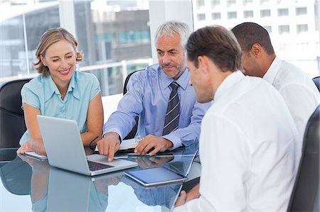 Business people using a laptop and digital tablet Stock Photo - Premium Royalty-Free, Code: 6109-06781406