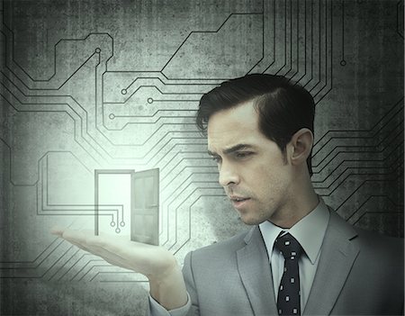 Concentrated businessman holding an open door Foto de stock - Sin royalties Premium, Código: 6109-06781420