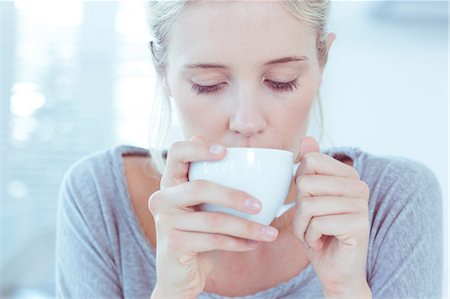 person drinking cup of coffee - Woman drinking tea Stock Photo - Premium Royalty-Free, Code: 6109-06781543