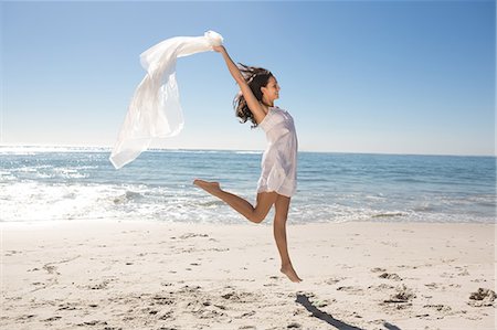 sarong - Woman with sarong jumping Stock Photo - Premium Royalty-Free, Code: 6109-06781550