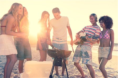 Friends having a barbecue on the beach Stock Photo - Premium Royalty-Free, Code: 6109-06781570