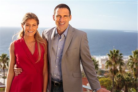 sophisticate - Couple smiling at camera on balcony Stock Photo - Premium Royalty-Free, Code: 6109-06781584