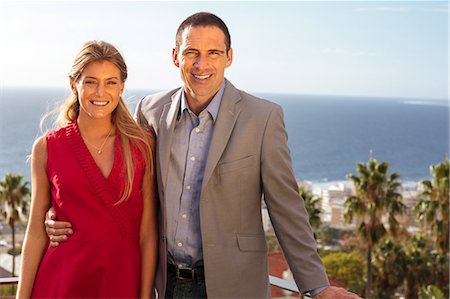 sophisticated male - Couple smiling at camera on balcony Stock Photo - Premium Royalty-Free, Code: 6109-06781584